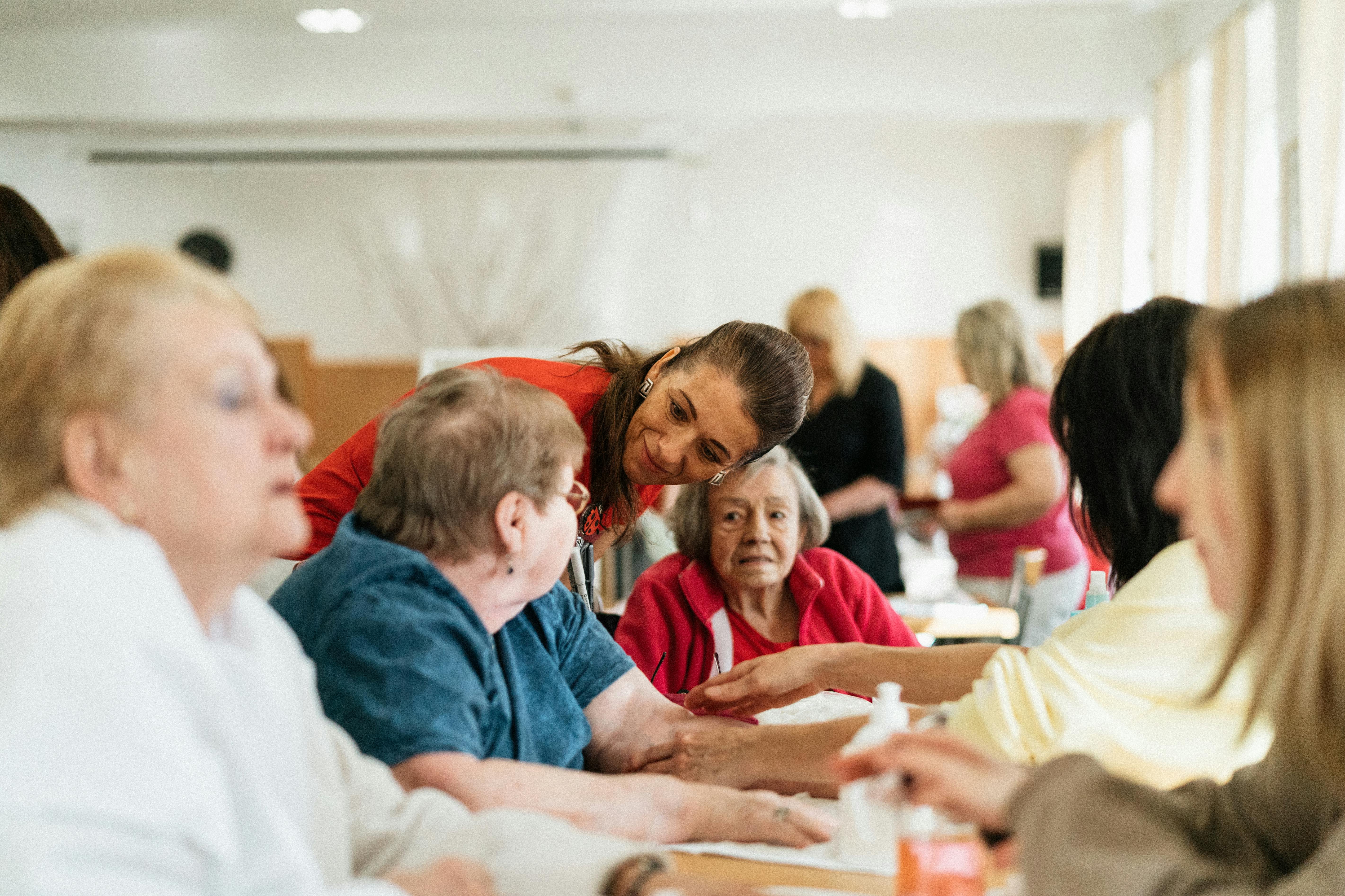Caregiver assisting seniors at a UNSVCC community gathering